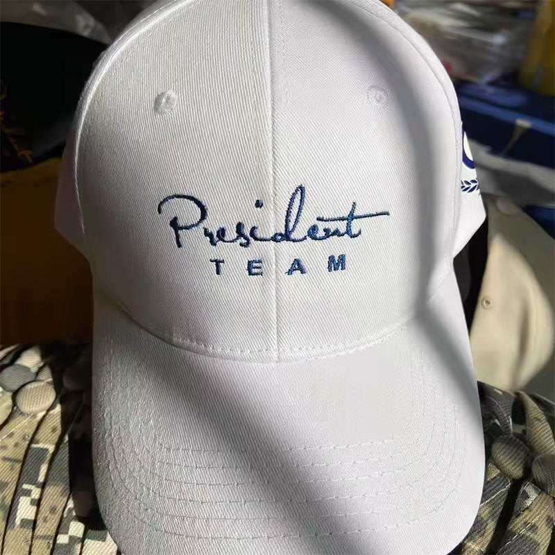 White cotton twill cap with an embroidered script team logo on the front panel