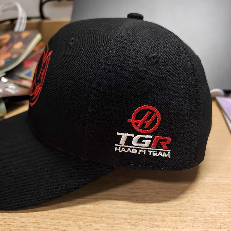 Black cap with a red and white embroidered racing team logo on the side