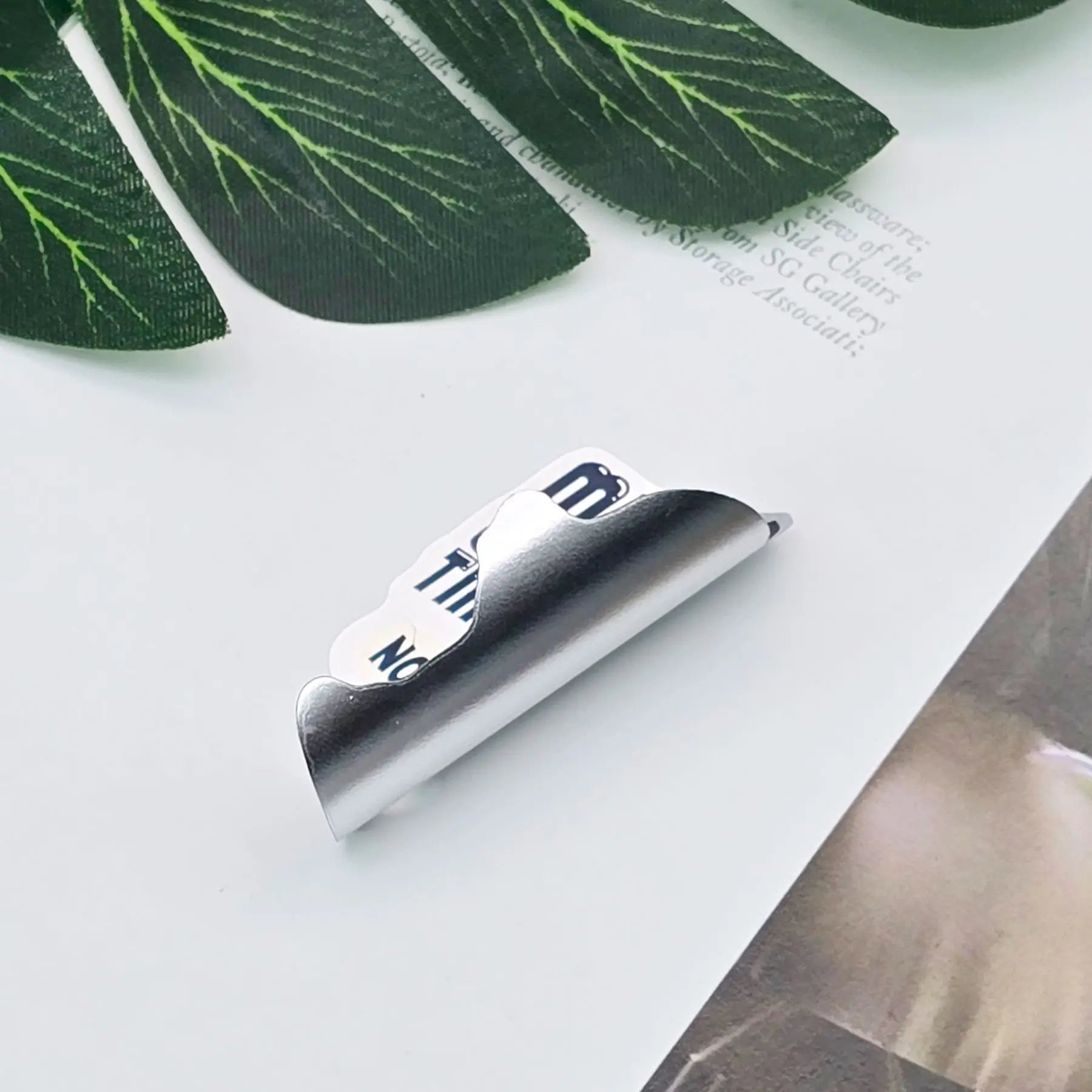 Matte silver custom stickers applied on product packaging for branding