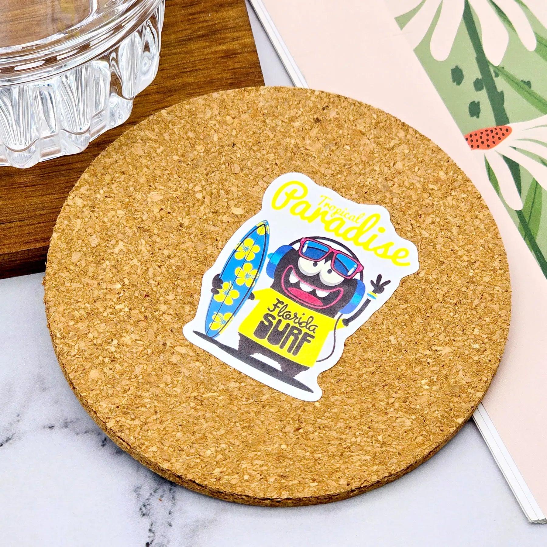 Custom waterproof PVC sticker applied on drink coaster, showing water resistance and vibrant full-color print quality