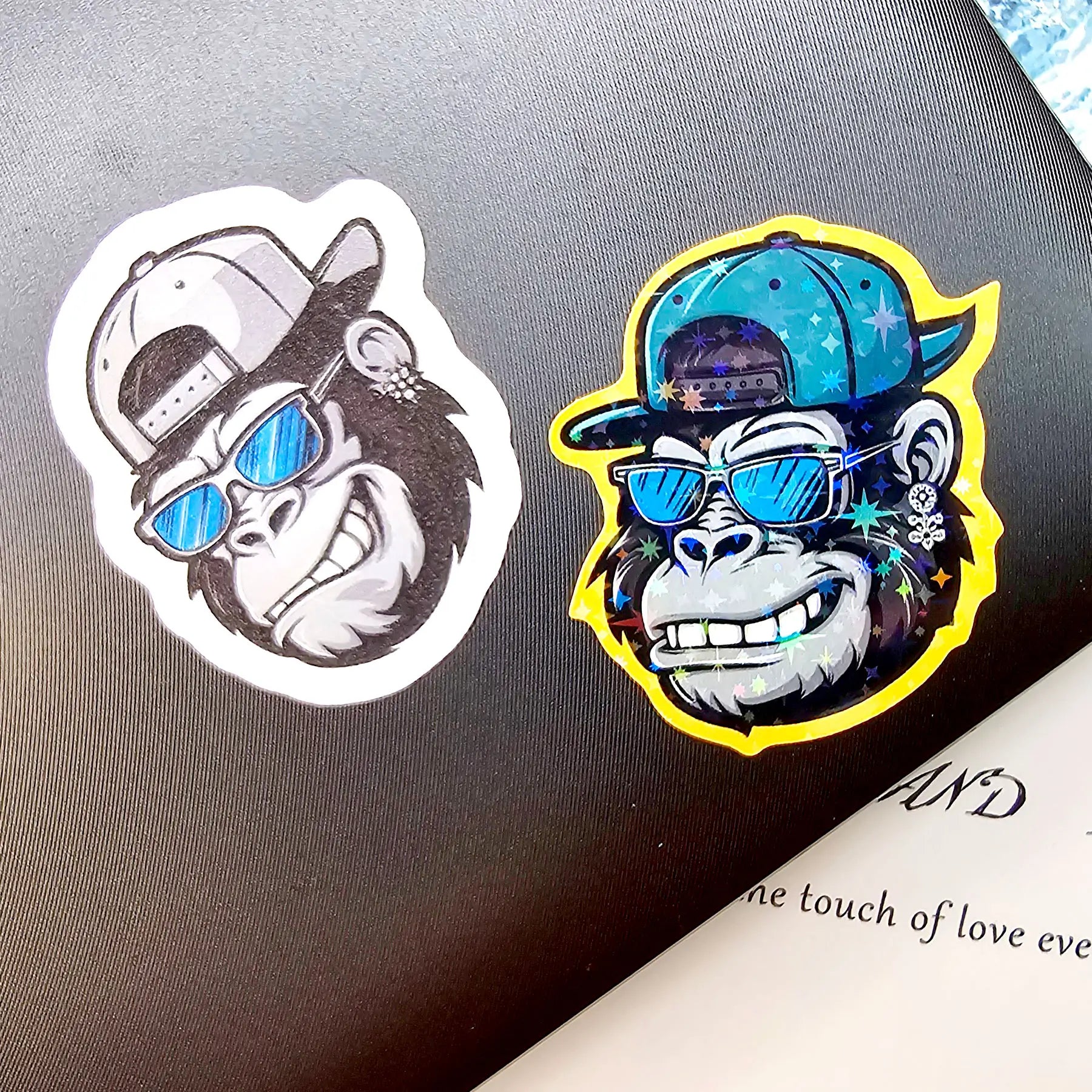 Side by side display of custom die cut stickers in matte, glossy and holographic finishes highlighting premium laminate coating quality